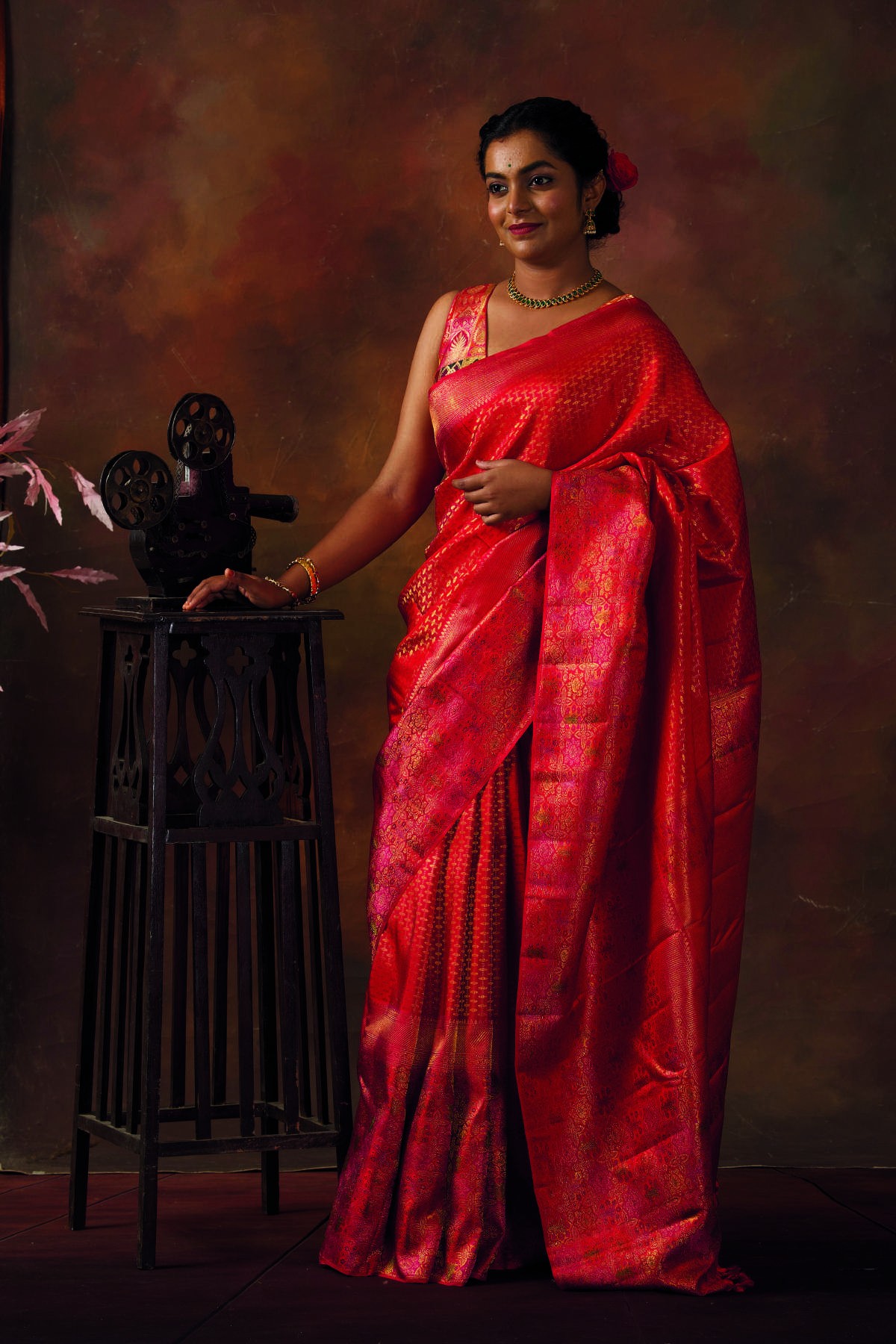 Woman wearing a crimson Kanjivaram silk saree